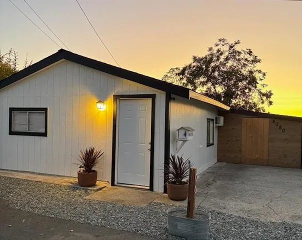 a view of a house with a tree