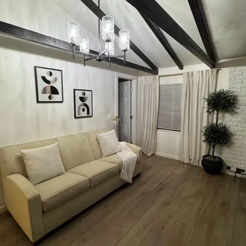 a bedroom with a bed and painting on the wall