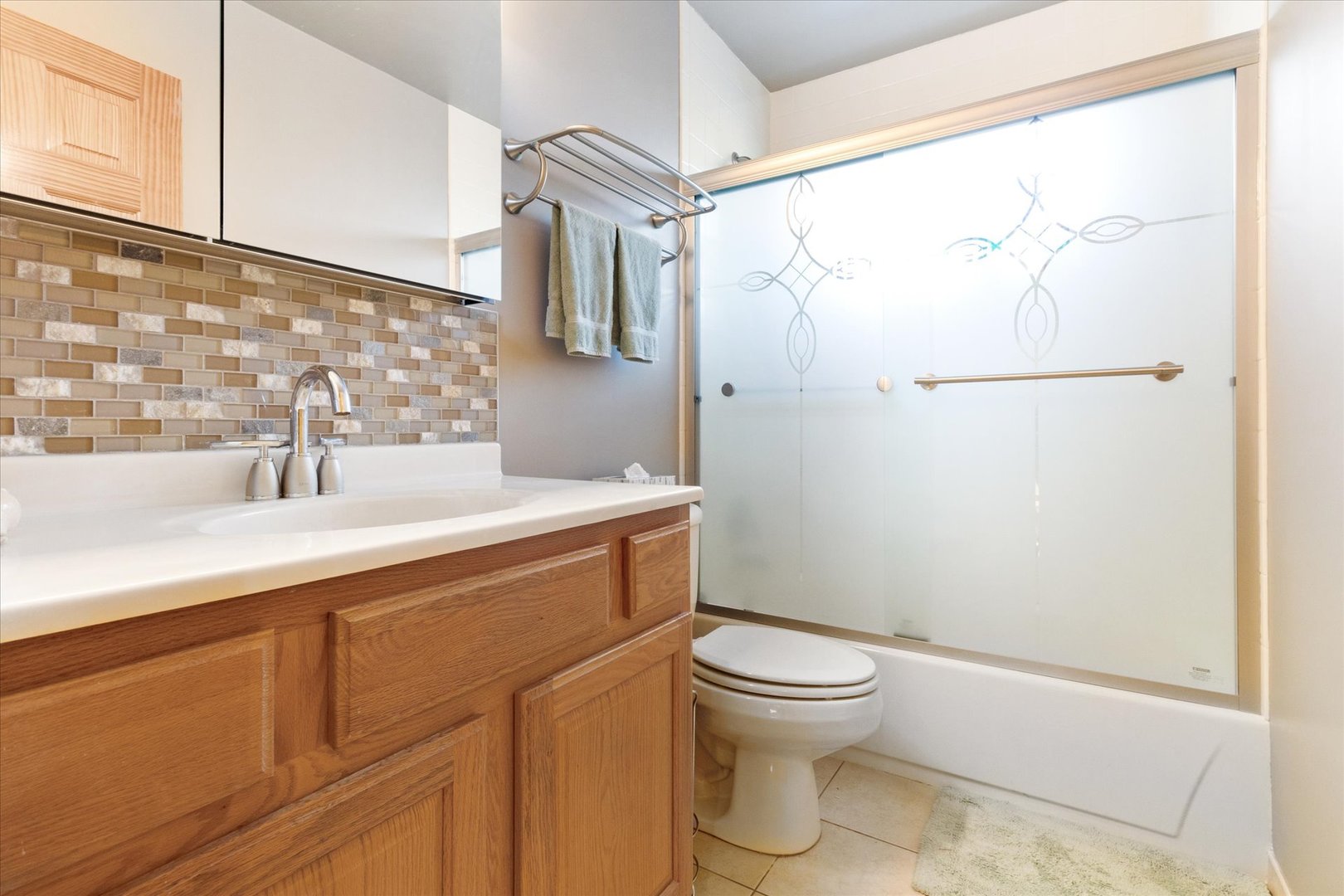 356 East Church Street Elmhurst, IL 60126 - Photo 10 of 16 a bathroom with a sink a toilet and shower