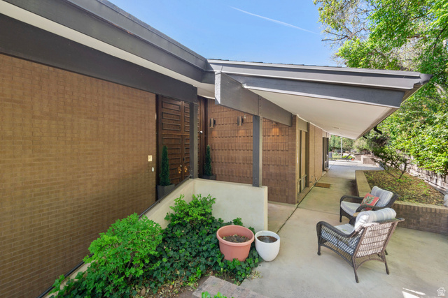 1900 North 100 East Provo, UT 84604 - Photo 4 of 49 Mid-century modern exterior featuring a brown brick facade and a wide covered entryway