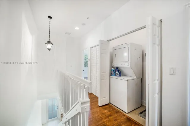 a view of a hallway with white walls and entryway