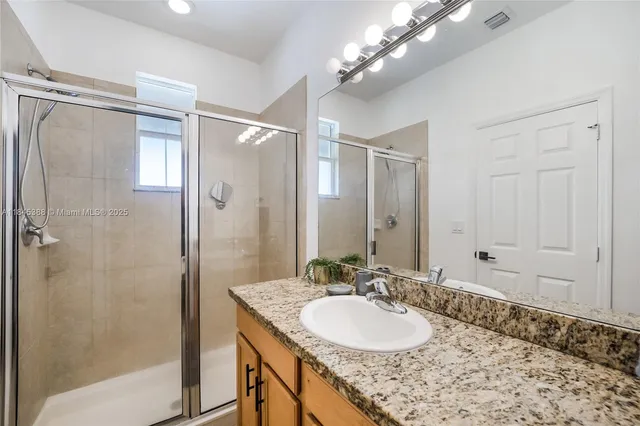 a bathroom with a sink double vanity and a mirror
