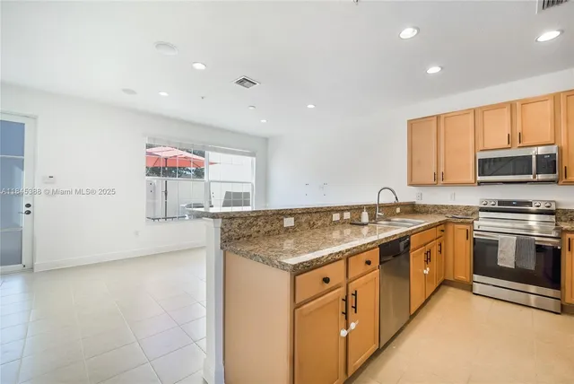 a kitchen that has a sink and a stove