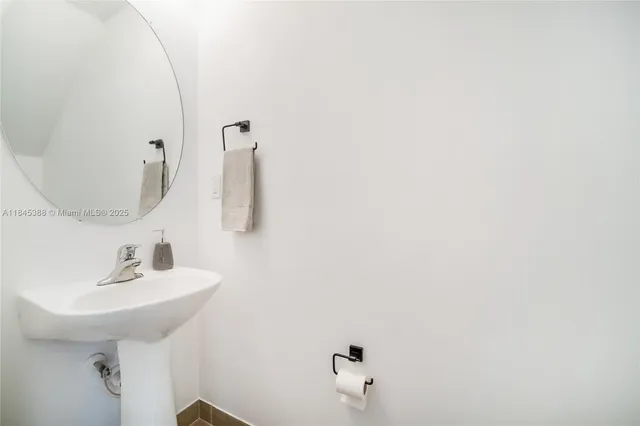 a bathroom with a sink and mirror