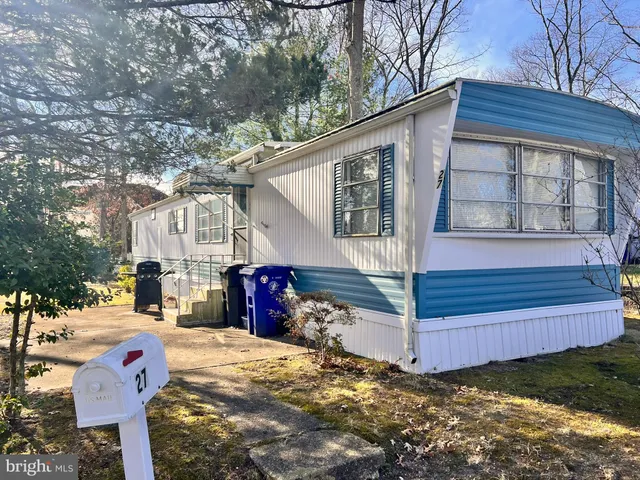 a view of a house with a yard and wooden fence