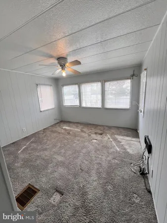 a bed sitting in a room next to a window
