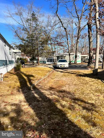 a view of a house with a wooden fence and a bench