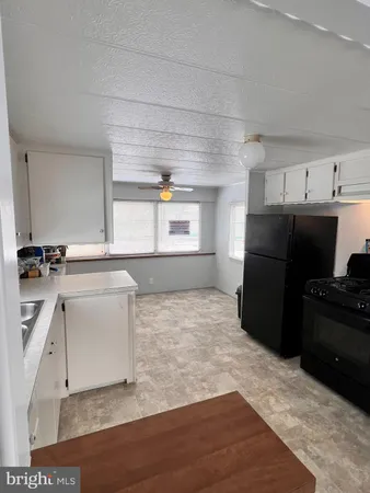 a stove top oven sitting inside of a kitchen