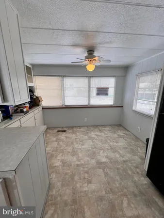 a bedroom with a bed and a chandelier fan