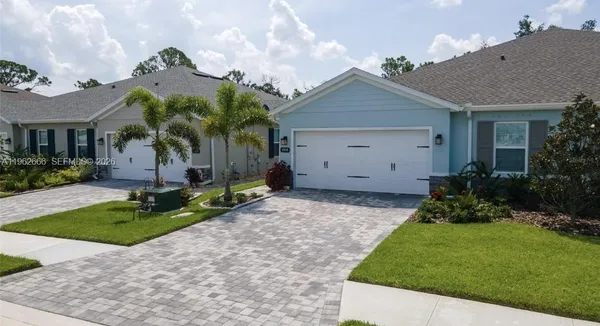 a view of a house with a small yard and plants