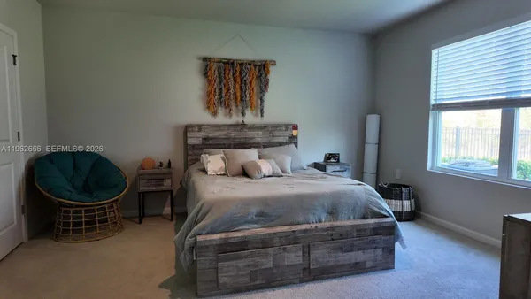 a bedroom with a bed closet and window