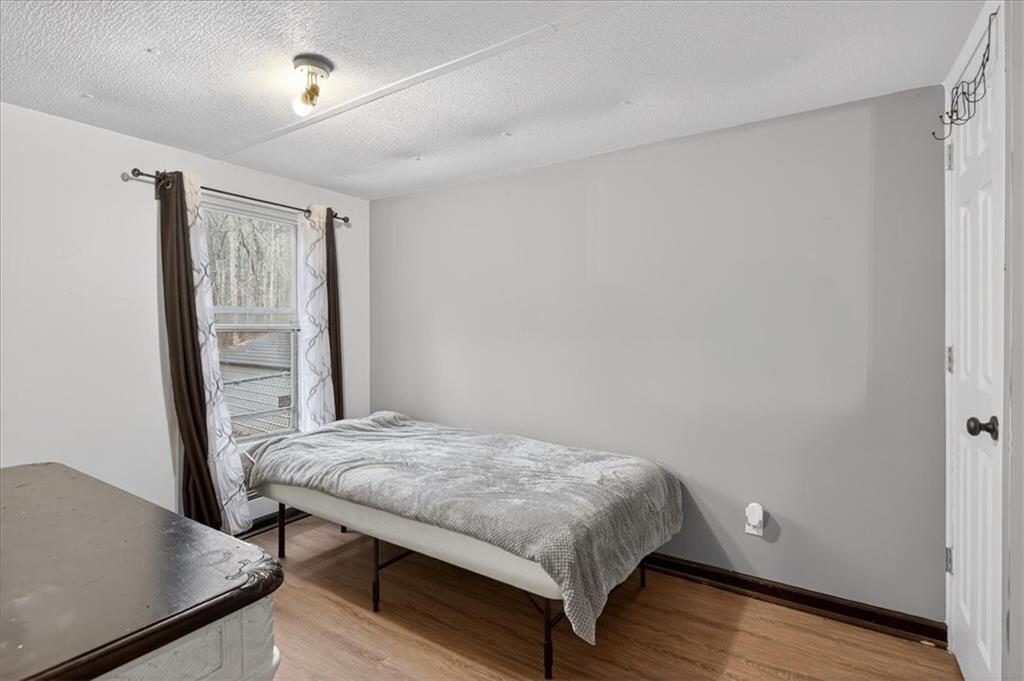 323 Ball Field Road Waleska, GA 30183 - Photo 16 of 39 a bedroom with a bed and a table in it