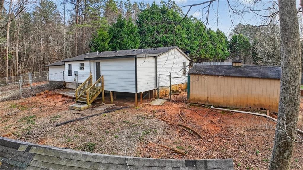323 Ball Field Road Waleska, GA 30183 - Photo 24 of 39 a view of a house that has a small yard and large trees