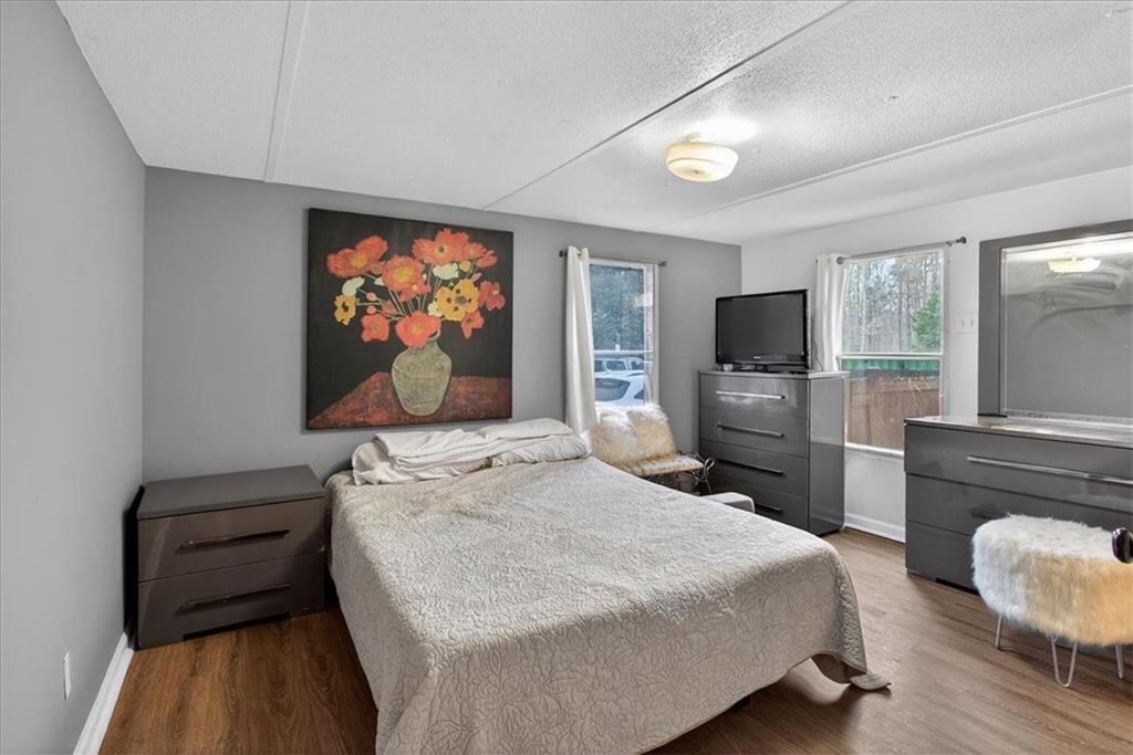 323 Ball Field Road Waleska, GA 30183 - Photo 10 of 39 a bedroom with a bed and a flat screen tv