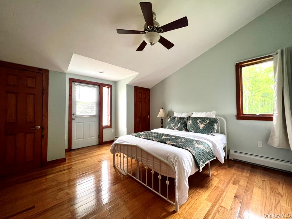 1837 Rich Road Franklin, NY 13775 - Photo 28 of 50 a bedroom with a large bed chandelier and a window
