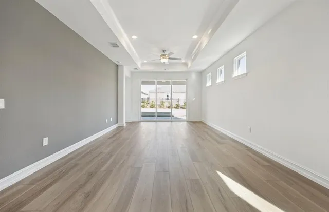 wooden floor in an empty room with a window