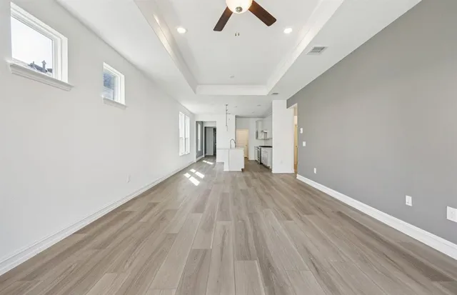 a view of empty room with wooden floor