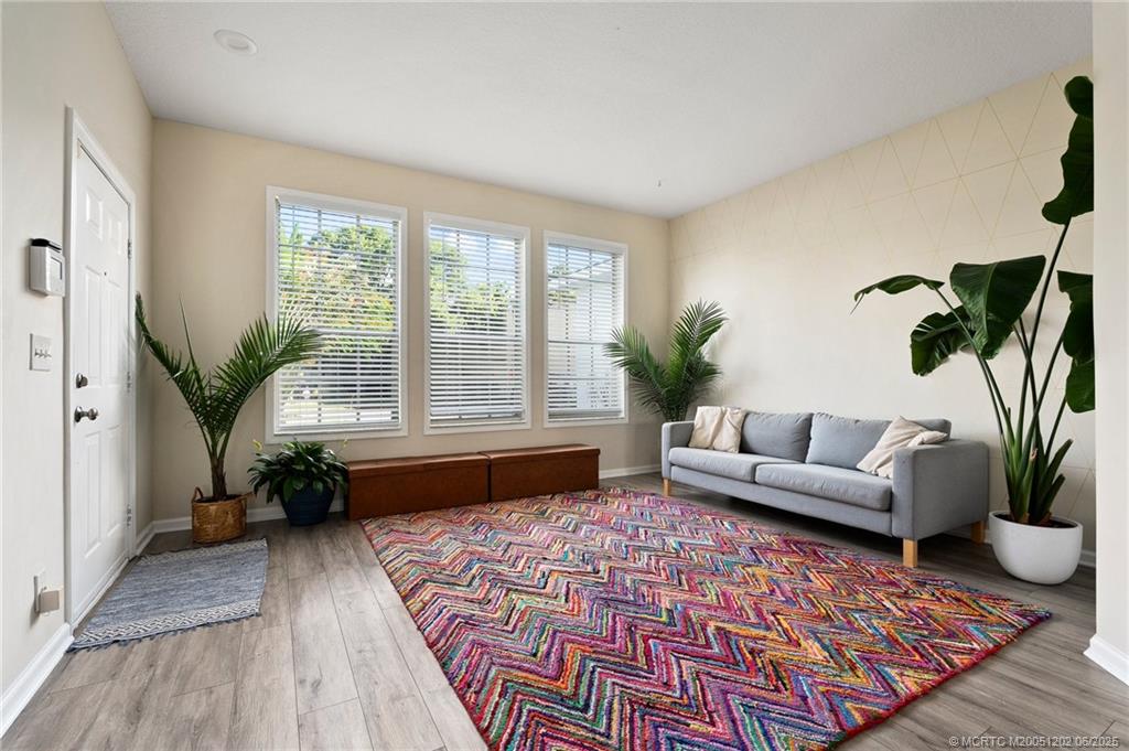 6351 Adams Street Jupiter, FL 33458 - Photo 11 of 42 a living room with furniture and a potted plant