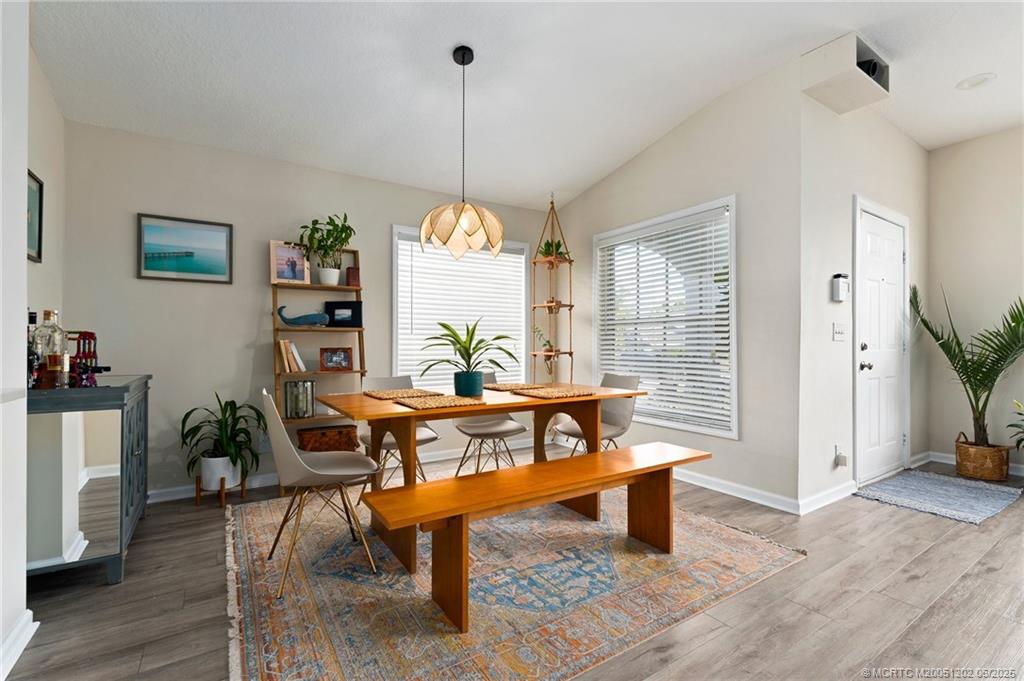 6351 Adams Street Jupiter, FL 33458 - Photo 14 of 42 a view of a dining room with furniture window and wooden floor