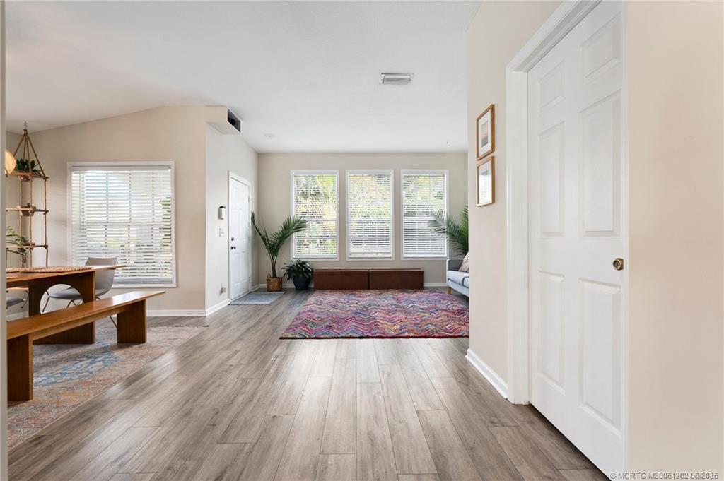 6351 Adams Street Jupiter, FL 33458 - Photo 15 of 42 a view of a hallway with wooden floor and a living room