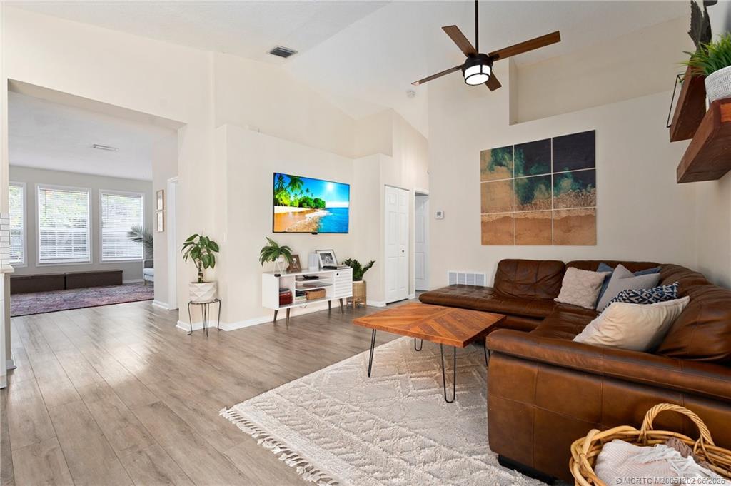 6351 Adams Street Jupiter, FL 33458 - Photo 16 of 42 a living room with furniture and a flat screen tv