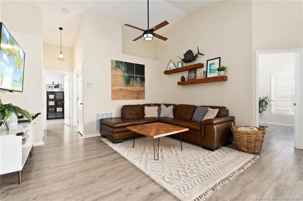 6351 Adams Street Jupiter, FL 33458 - Photo 17 of 42 a living room with furniture and a table
