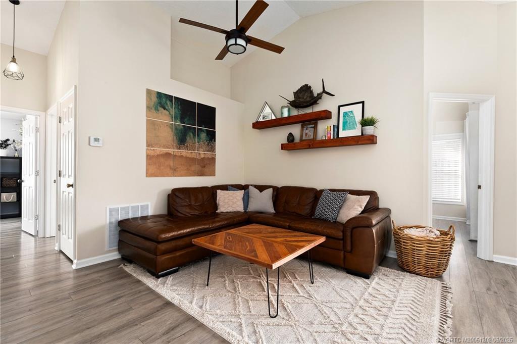 6351 Adams Street Jupiter, FL 33458 - Photo 18 of 42 a living room with furniture a rug and a window