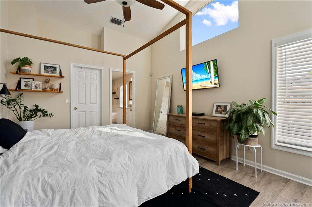 6351 Adams Street Jupiter, FL 33458 - Photo 20 of 42 a bedroom with a bed and a potted plant