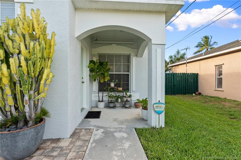 6351 Adams Street Jupiter, FL 33458 - Photo 2 of 42 a front view of a house with a garden