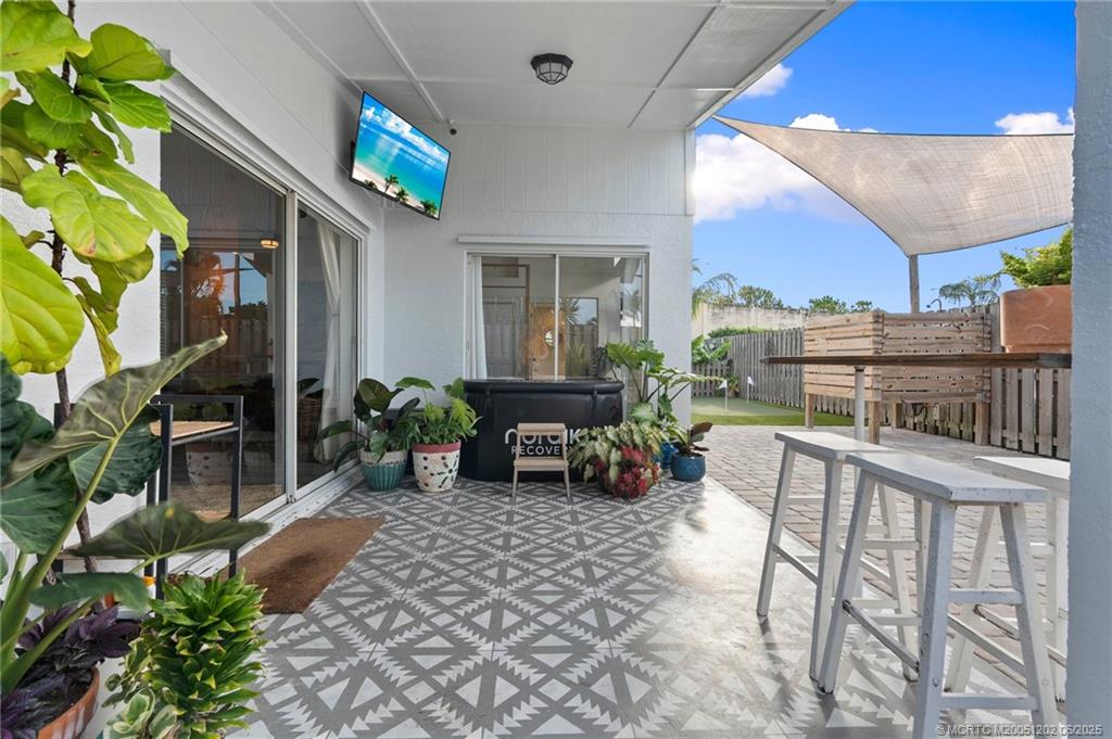 6351 Adams Street Jupiter, FL 33458 - Photo 30 of 42 a view of a chairs and table in a patio