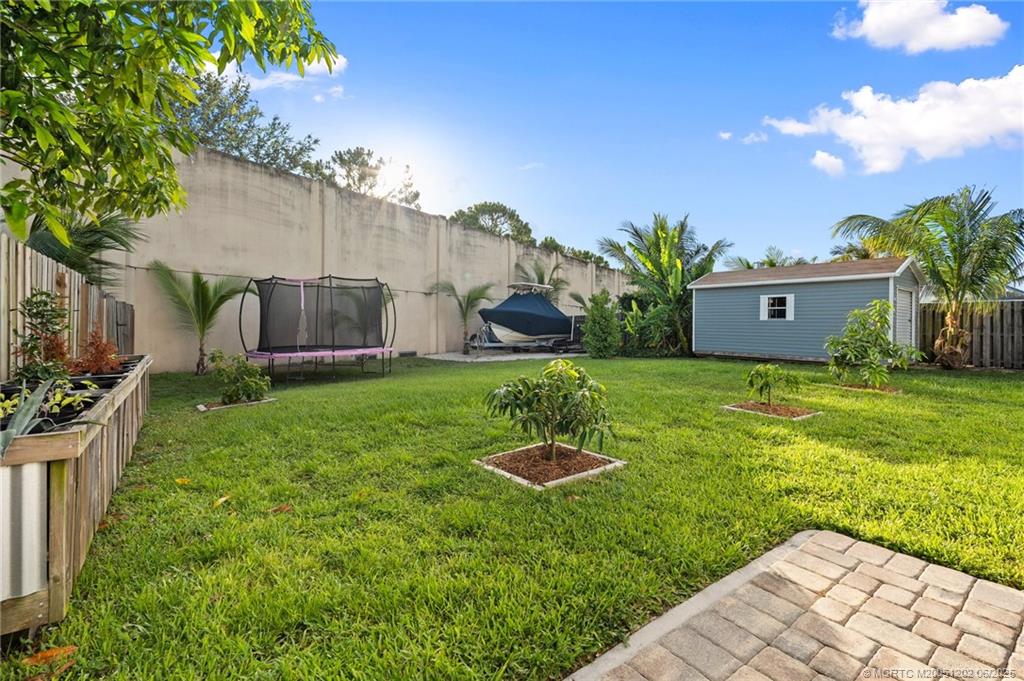 6351 Adams Street Jupiter, FL 33458 - Photo 38 of 42 a view of a house with a backyard