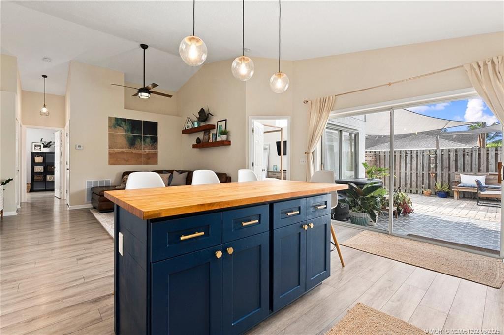 6351 Adams Street Jupiter, FL 33458 - Photo 8 of 42 a kitchen with stainless steel appliances granite countertop a sink a counter space and wooden floor