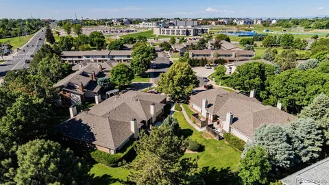 an aerial view of multiple houses with yard