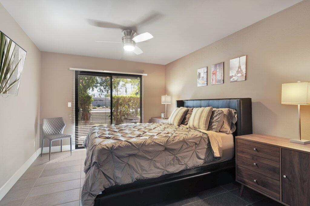 1050 Ramon Road, Unit 3 Palm Springs, CA 92264 - Photo 8 of 28 a bedroom with a bed and a chair