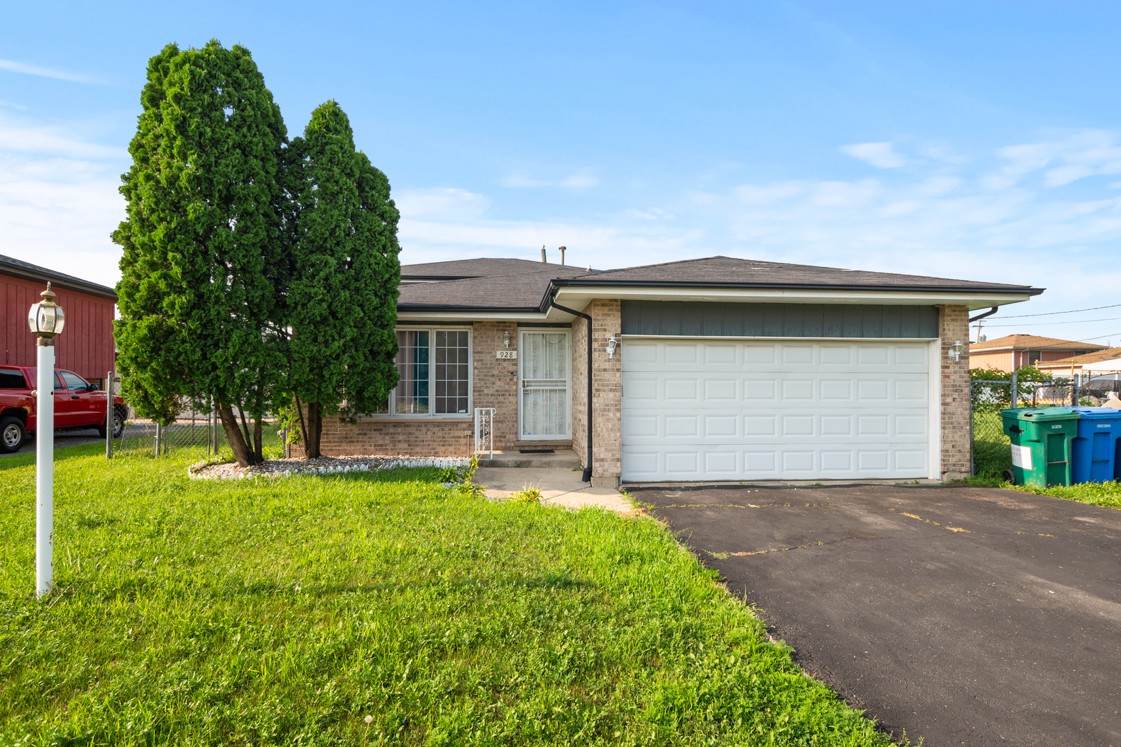 928 East 153rd Street Phoenix, IL 60426 - Photo 1 of 24 a front view of house with yard and green space