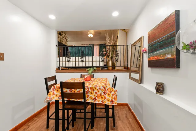 a dining room with furniture and wooden floor