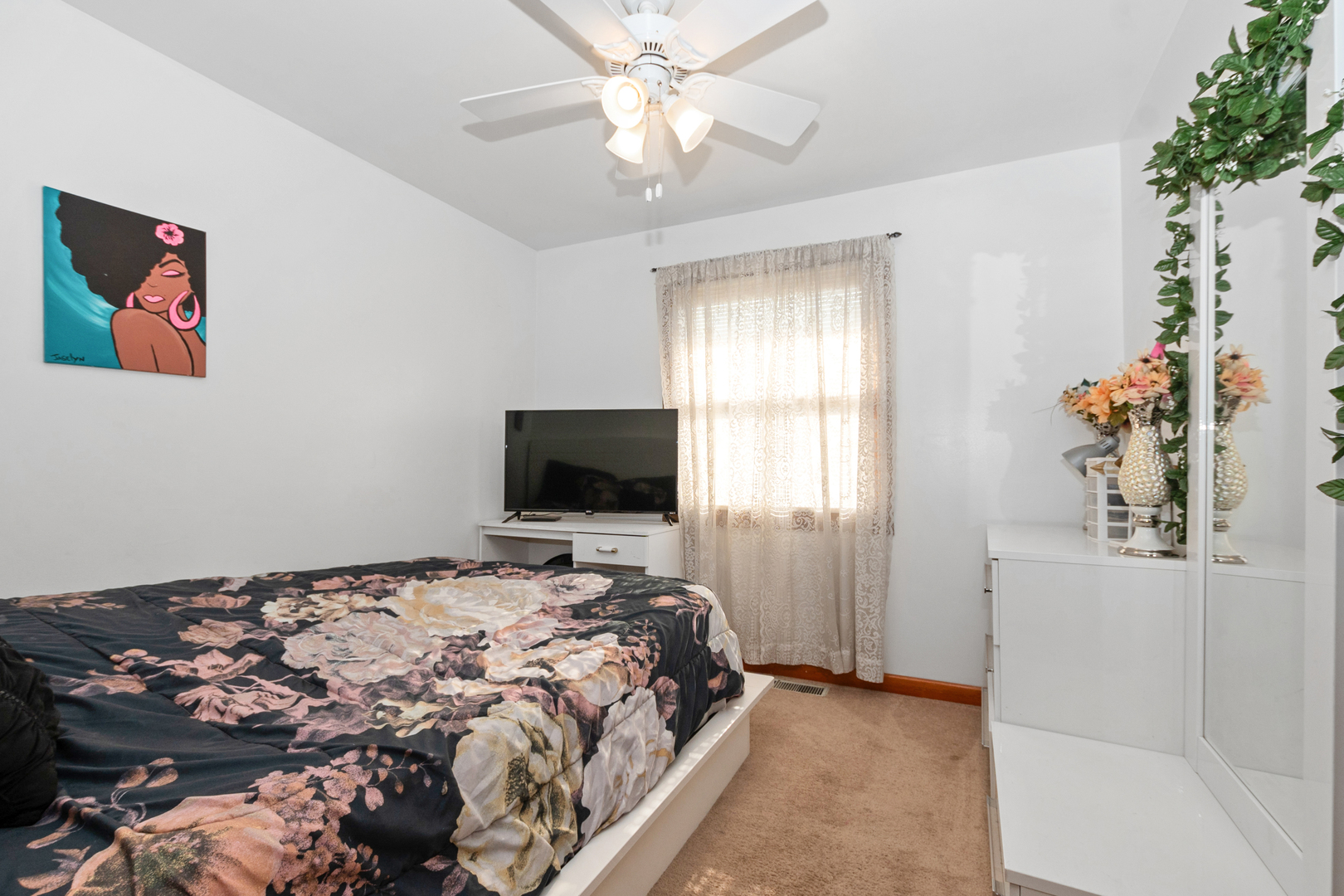 928 East 153rd Street Phoenix, IL 60426 - Photo 21 of 24 a bedroom with a bed and a flat screen tv