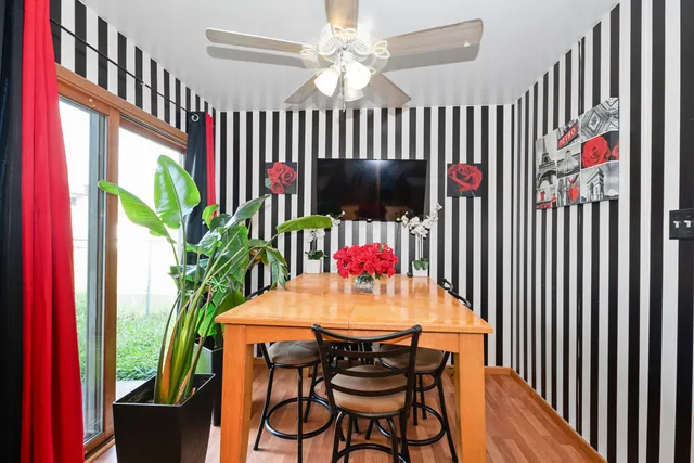 a dining room with furniture a potted plant and a chandelier