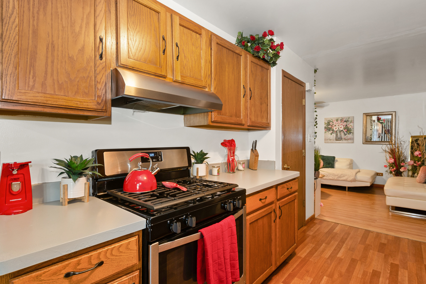 928 East 153rd Street Phoenix, IL 60426 - Photo 10 of 24 a kitchen with stainless steel appliances granite countertop a stove a sink dishwasher and cabinets with wooden floor