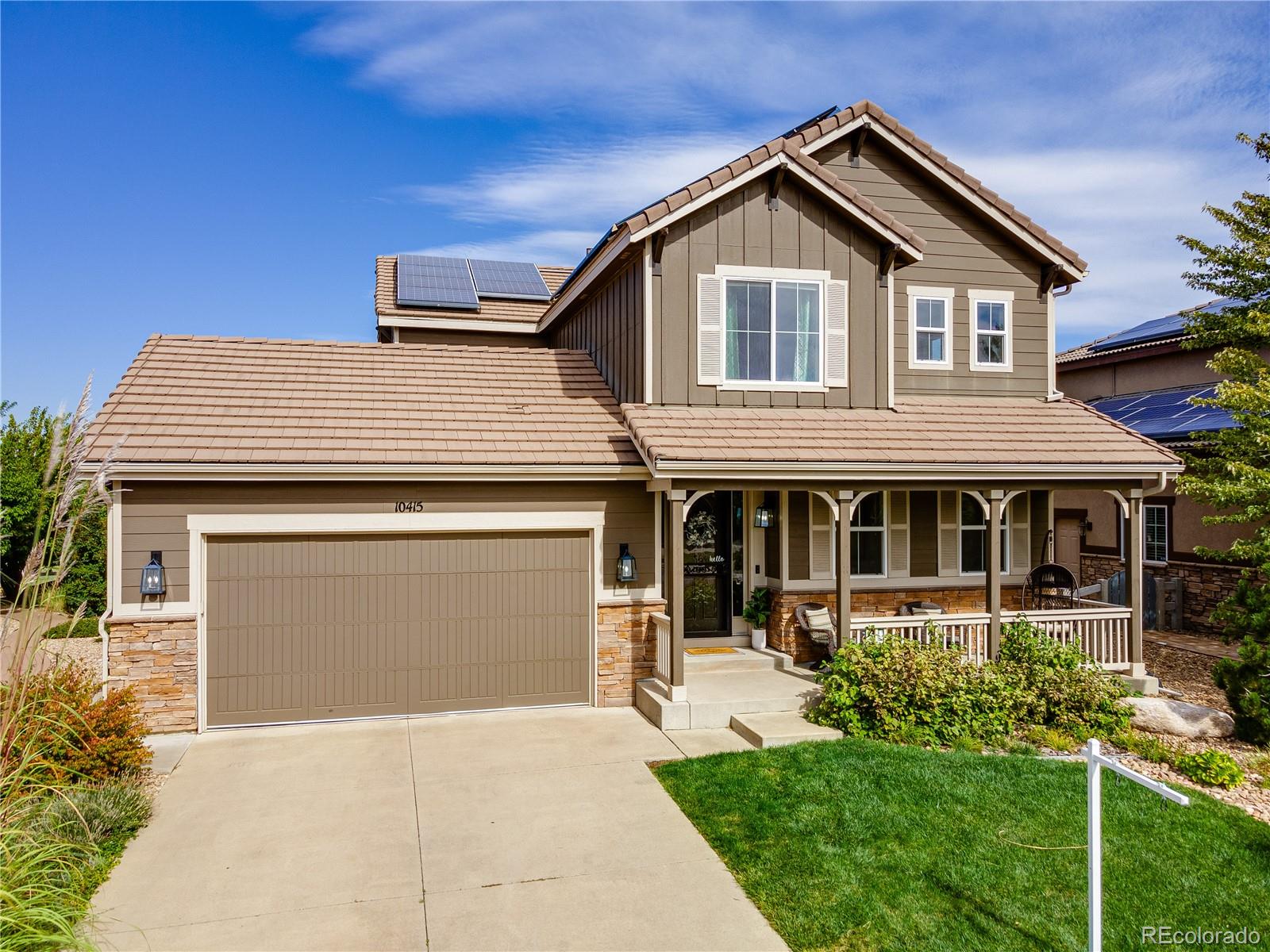 10415 Startrail Court Highlands Ranch, CO 80126 - Photo 1 of 49 a front view of a house with a yard and garage