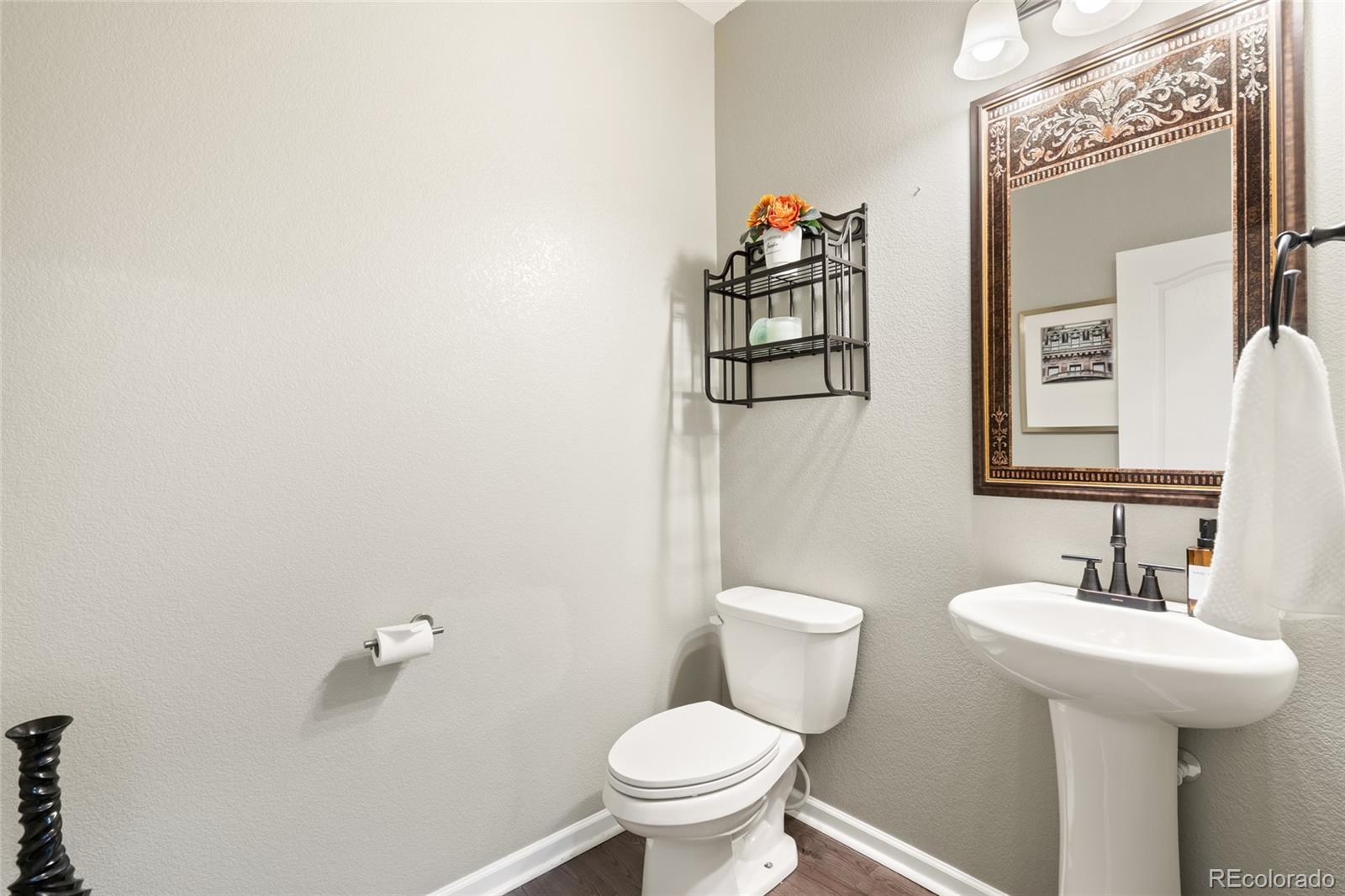10415 Startrail Court Highlands Ranch, CO 80126 - Photo 26 of 49 a bathroom with a toilet sink and mirror
