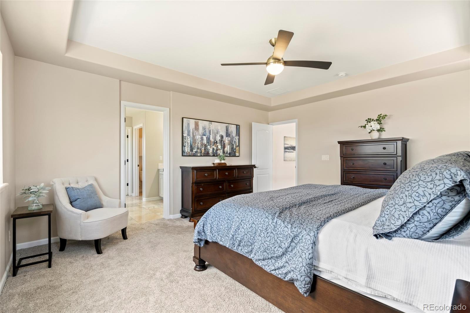 10415 Startrail Court Highlands Ranch, CO 80126 - Photo 28 of 49 a bedroom with a bed and a chandelier