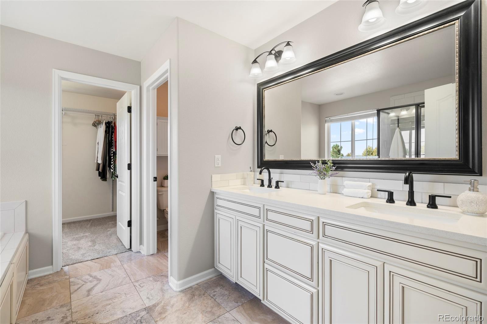 10415 Startrail Court Highlands Ranch, CO 80126 - Photo 29 of 49 a spacious bathroom with a double vanity sink mirror and