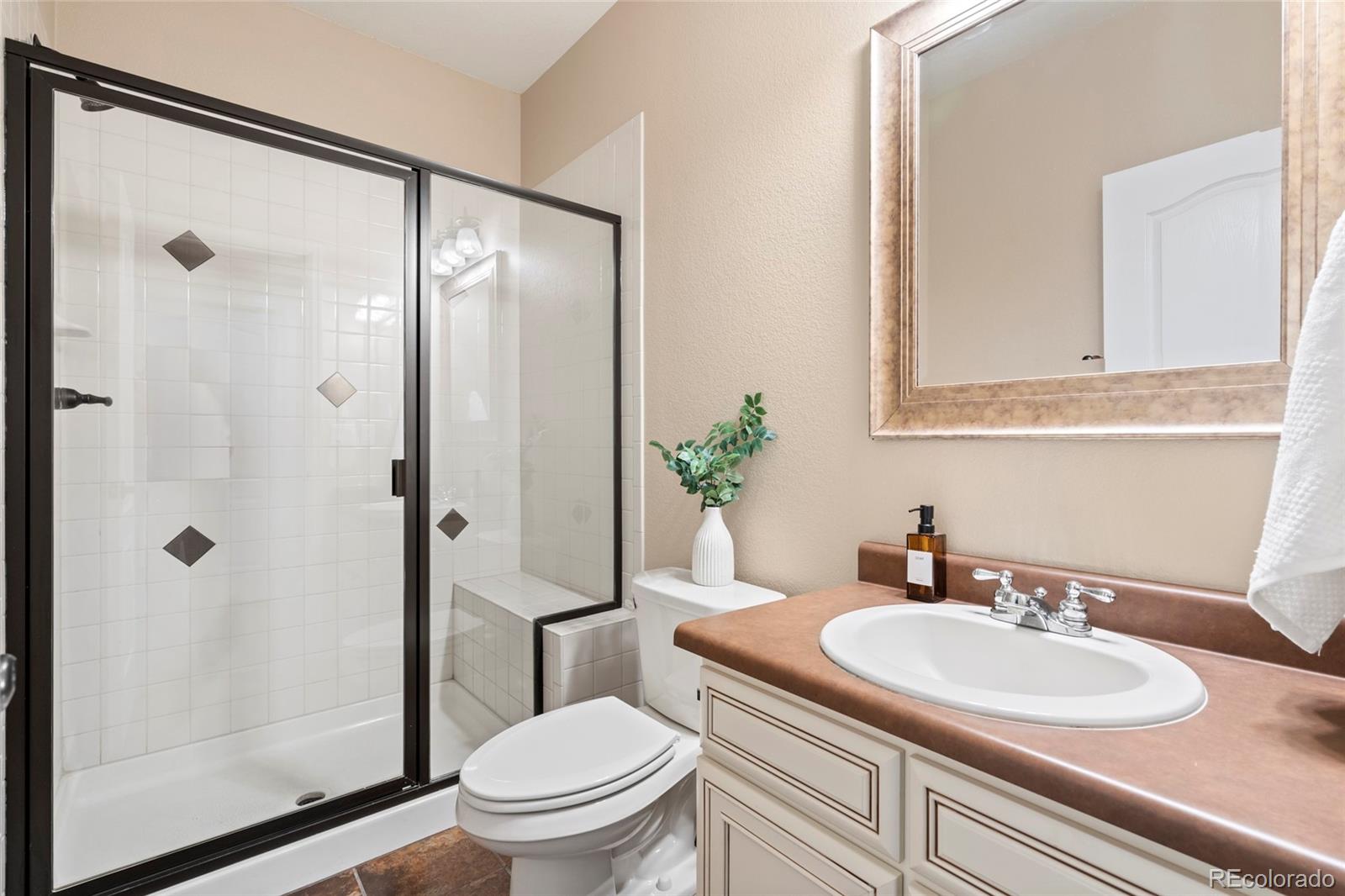 10415 Startrail Court Highlands Ranch, CO 80126 - Photo 41 of 49 a bathroom with a sink toilet and shower