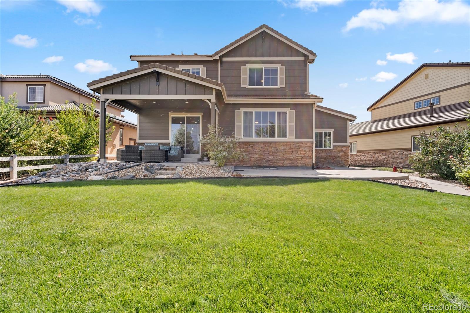 10415 Startrail Court Highlands Ranch, CO 80126 - Photo 45 of 49 a front view of a house with a garden and yard