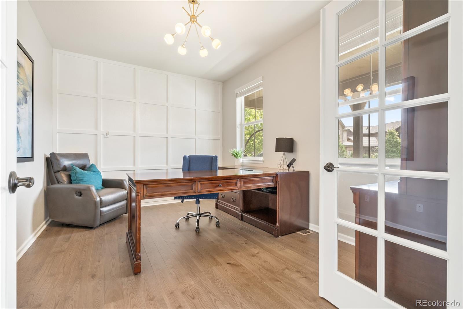 10415 Startrail Court Highlands Ranch, CO 80126 - Photo 5 of 49 a workspace with wooden floor