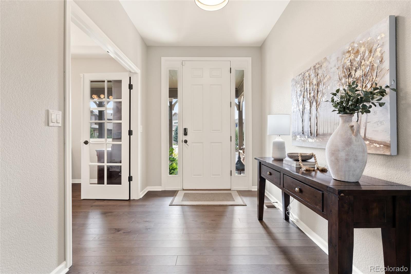 10415 Startrail Court Highlands Ranch, CO 80126 - Photo 7 of 49 a view of a hallway with furniture and front door