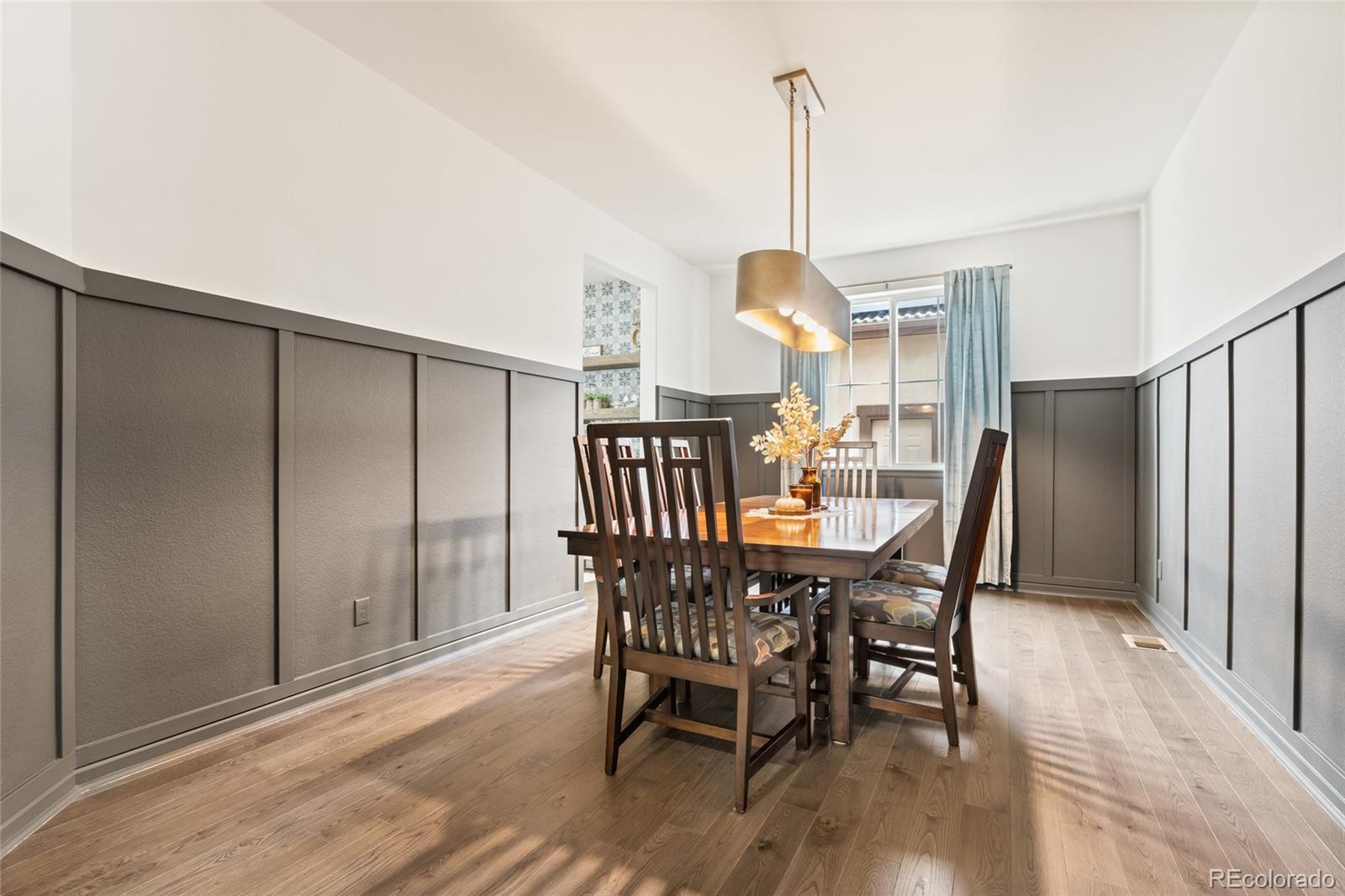 10415 Startrail Court Highlands Ranch, CO 80126 - Photo 10 of 49 a view of a dining room with furniture window and wooden floor