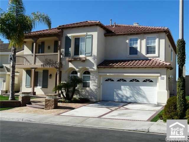Beautiful Spanish architecture offers great curb appeal with a porch and balcony.
