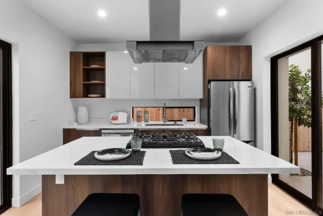 a kitchen with stainless steel appliances a stove refrigerator sink and cabinets